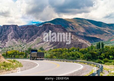Lonely truck on route 40 through Colorfull mountains at the Parque Nacional Los Cardones (National Park) in the Salta Provence , Argentina Stock Photo