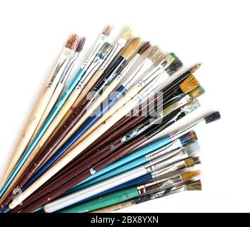 Set of dirty used paint bristles isolated on white background. Paint brushes in various colors Stock Photo