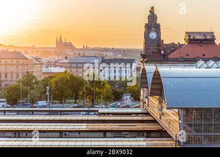 Prague Main Train Station, Hlavni nadrazi, with historical buildings and Prague Castle on the background at sunset time. Prague, Czech Republic. Stock Photo