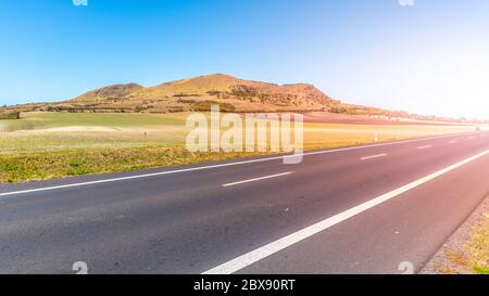 Rana Mountain and asphalt road near Louny in Central Bohemian Highlands on sunny summer day, Czech Republic. Stock Photo