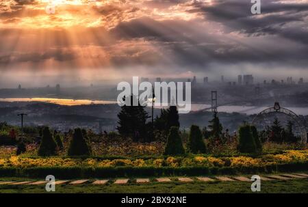 Cityscape of Istanbul with Bosphorus, skyscrapers, and 15th July Martyrs Bridge Bosphorus Bridge from Camlica hill at sunset Istanbul, Turkey Stock Photo