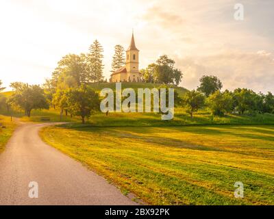 Small church in the middle of lush green spring landscape on sunny day. St. Peter and Pauls church at Bysicky near Lazne Belohrad, Czech Republic. Stock Photo