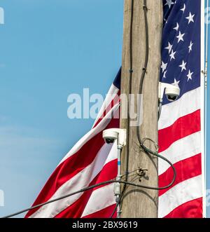 American flag with cameras mounted on a pole near by Stock Photo