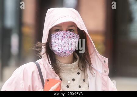 WIMBLEDON LONDON, UK. 6 June 2020. Pedestrians and shoppers wearing various types of  face coverings against covid-19 infections in Wimbledon town centre on a cold rainy day. Credit: amer ghazzal/Alamy Live News