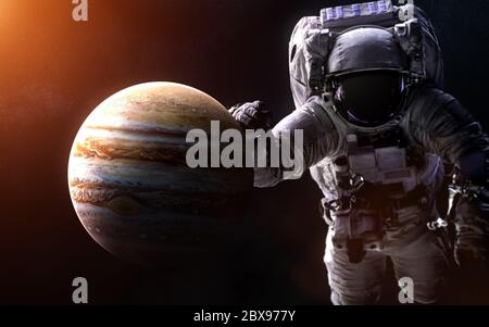 Jupiter on a blurred background with a giant astronaut Stock Photo