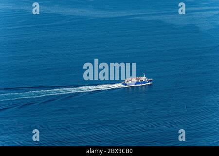 Blue ferry boat with many tourists during sailing to the Cinque Terre in the Mediterranean Sea. Gulf of La Spezia, Liguria, Italy, Europe Stock Photo
