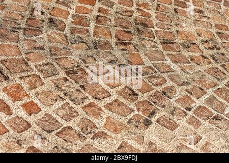 Extreme close-up of a porphyry stone floor called Sanpietrini or Sampietrini, typical urban paving in Italy, Bologna city, Emilia-Romagna, Europe Stock Photo