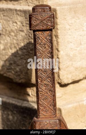 Closeup of an ancient wrought iron bollard to repair the corners of buildings. Bologna downtown, Emilia-Romagna, Italy, Europe Stock Photo