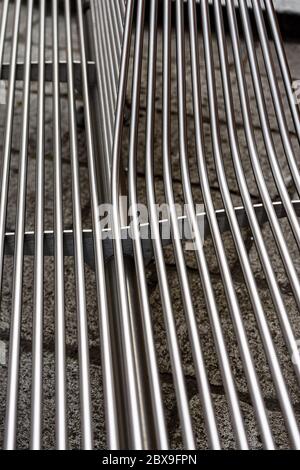 Extreme close-up of metal bars of a steel bench in downtown of Bologna city, Italy, Europe Stock Photo