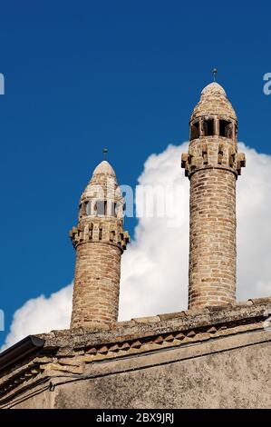 Close-up of two ancient chimneys and roof on a blue sky with clouds. Verona province, Veneto, Italy, Europe Stock Photo