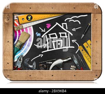 Home improvement concept - Work tools and a chalk drawing of a house in a black chalkboard with wooden frame, isolated on white background