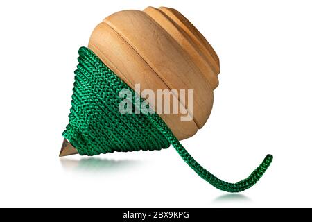 Close-up of a wooden spinning top with a green rope, isolated on white background. Vintage toy Stock Photo