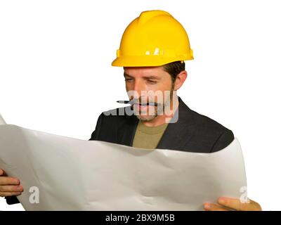 corporate portrait of young attractive and successful industrial engineer or architect in safety builder helmet checking building project blueprint ha Stock Photo