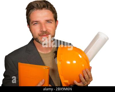corporate portrait of young attractive and successful industrial engineer or architect in safety builder helmet holding building project blueprint hap Stock Photo