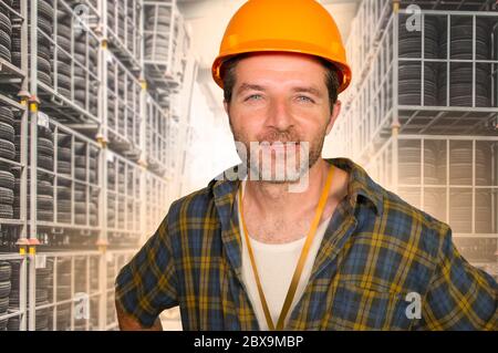 corporate portrait of blue collar worker man. Attractive and happy workman in safety helmet smiling confident posing relaxed as successful contractor Stock Photo