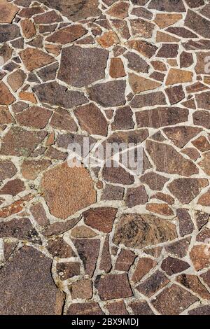 Close-up of an outdoor flooring made with irregular porphyry slabs, full frame, Italy, Europe Stock Photo