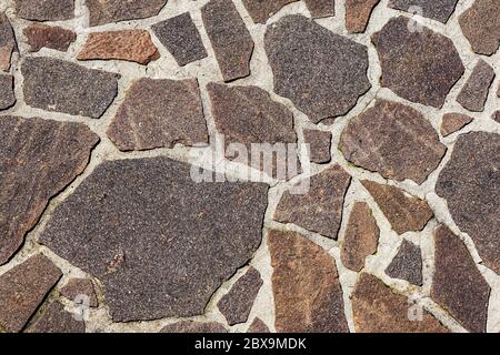 Close-up of an outdoor flooring made with irregular porphyry slabs, full frame, Italy, Europe Stock Photo