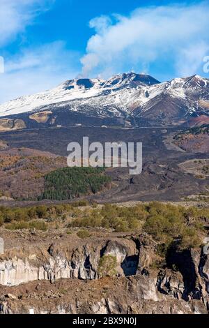 Mount Etna volcano with smoke and snow in winter. Catania, Sicily island, Italy, Europe Stock Photo