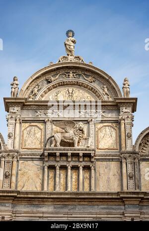 Venice. Close-up of the Scuola Grande di San Marco with the winged lion of saint Mark, building in Renaissance style. UNESCO world heritage site Stock Photo