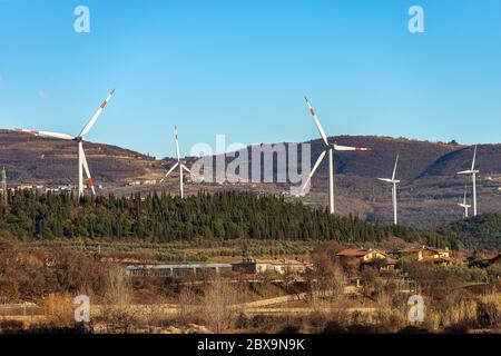 Group of white and red wind turbines over the hill. Affi village, Verona province, Veneto, Italy, Europe Stock Photo