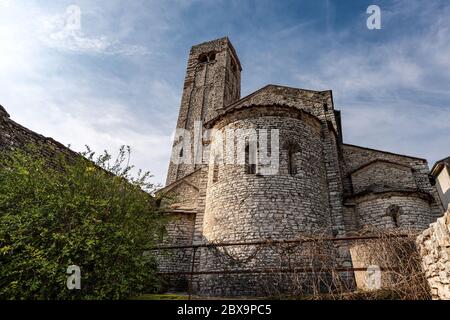 Parish Church of San Giorgio di Valpolicella or Ingannapoltron in Romanesque style (VII - XI century), bell tower and apse. Veneto, Verona, Italy