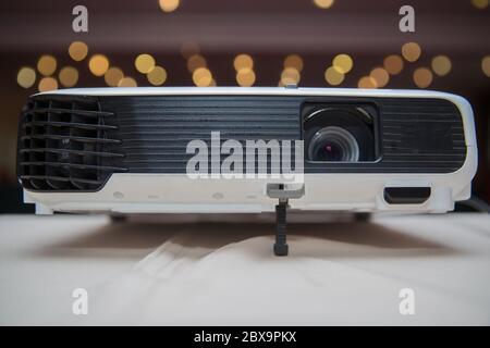 LCD Projector technology video presentation and home Entertainment object . mini led projector on wood table in a room projector home theater idea and Stock Photo