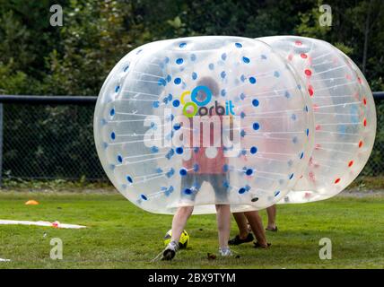 Saint John, New Brunswick, Canada - August 26, 2017: Events at the Dragon Boat Festival. People play Bubble Soccer. Stock Photo