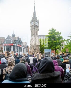 Black Lives Matter demonstration in Leicester city. Rain falls on protesters at The Clock Tower Stock Photo