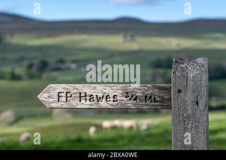 Wooden sign showing direction of footpath towards Hawes in the Yorkshire Dales National Park, UK. Stock Photo