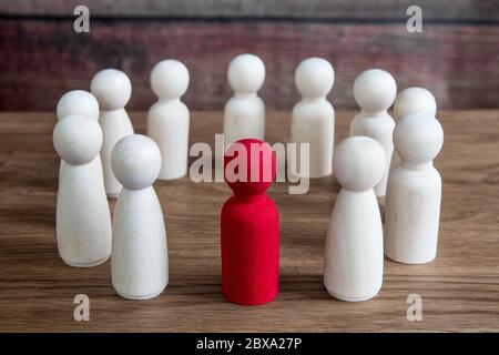 A business or social concept of generic figures grouped into a circle during a meeting, conference or forum with a leader, Manager or boss Stock Photo