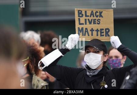 A young white woman demonstrating at a British Anti-Racism protest rally in the UK holding a sign that reads 'Black Lives Matter'. June 6 2020. Stock Photo