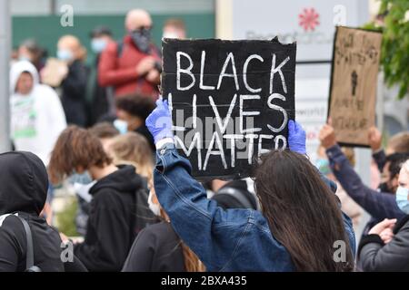 A young white woman demonstrating at a British Anti-Racism protest rally in the UK holding a sign that reads 'Black Lives Matter'. June 6 2020. Stock Photo