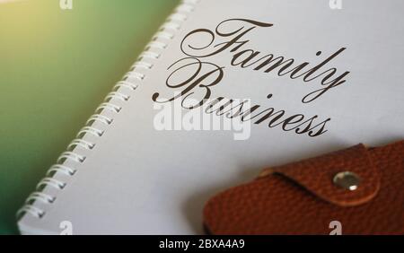 Family Business on notebook with wallet Small business enterprice unit startup development concept Stock Photo