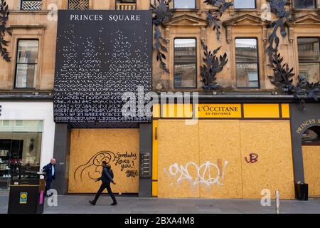 Glasgow, Scotland, UK. 6 June 2020. Normally busy shopping district of Buchanan Street in Glasgow city centre is almost deserted on a Saturday lunchtime. Shops and businesses remain closed and in many cases boarded up. Upmarket Princes Square shopping arcade is boarded up. Iain Masterton/Alamy Live News