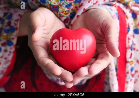 Red heart in hands, donate or charity concept Stock Photo