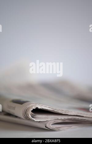 Newspaper on a table with narrow depth of field. Space for text above newspaper Stock Photo