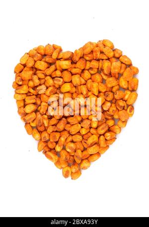 Organic Salted roasted corn in heart symbol isolated on white background Stock Photo