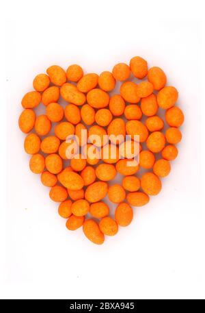 Organic salted peanuts  in heart symbol isolated on white background Stock Photo