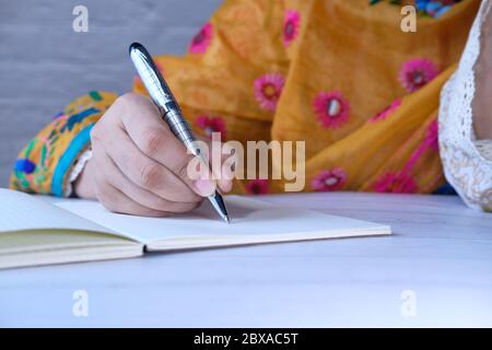 asian women hand writing in notebook with pen Stock Photo