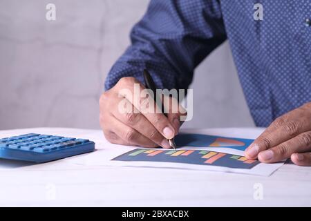 businessman analyzing financial data at office desk  Stock Photo