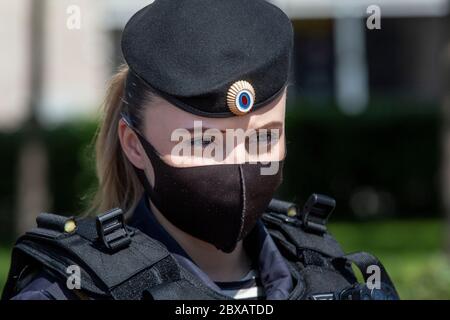 Moscow, Russia. 6th of June, 2020 Close-up view of a police officer wearing a protective mask and gloves while provides security at a public event on Tverskaya street in Central Moscow during the COVID-19 coronavirus epidemic in Russia Stock Photo