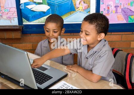 Kids using laptop computer in class Stock Photo