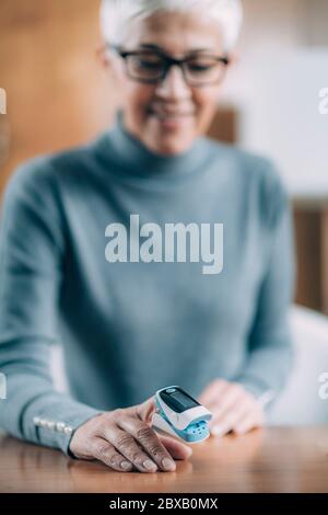 Using pulse oximeter at home to test oxygen in blood Stock Photo