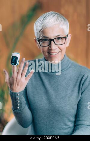 Using pulse oximeter at home to test blood oxygen level Stock Photo
