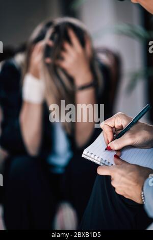 Psychotherapist taking notes Stock Photo