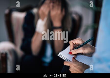 Psychiatrist in cognitive behavioural therapy session Stock Photo