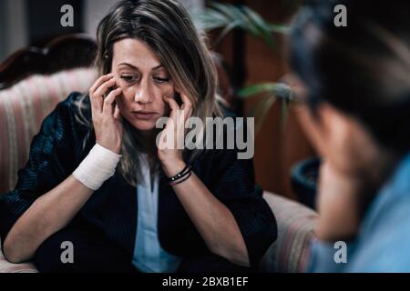 Depressed woman in session with psychotherapist Stock Photo