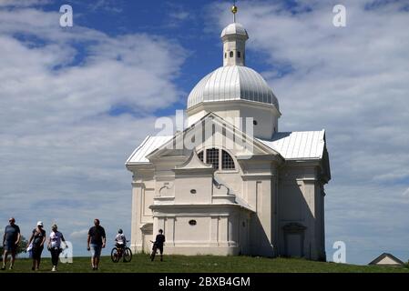 June 6, 2020, Mikulov, Czech Republic: Tourists enjoy the sunny weather and relaxing on the beautiful Holy Hill in Mikulov.A low angle view at Holy Hill (originally Tanzberg Hill) is one of the landmarks of Mikulov that cannot be overlooked. Its foundation stone was consecrated on 2 July 1623. A Way of the Cross comprised of seven chapels was also established on the top of Holy Hill at that time. The town Mikulov is part of the historic Moravia region, located directly on the border with Lower Austria. Mikulov is situated between the Pavlovske vrchy hilly area and the edge of the Mikulov Hig Stock Photo