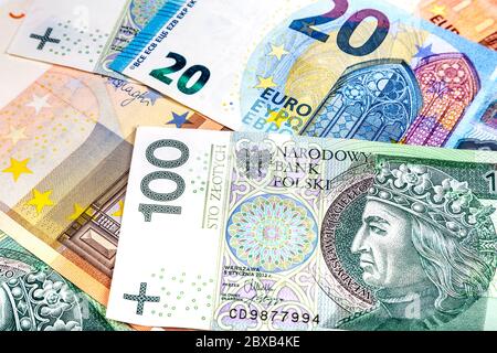 Scattered Polish Zloty PLN and Euro EUR currency notes Stock Photo