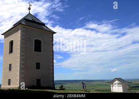 June 6, 2020, Mikulov, Czech Republic: Tourists enjoy the sunny weather and relaxing on the beautiful Holy Hill in Mikulov.A low angle view at Holy Hill (originally Tanzberg Hill) is one of the landmarks of Mikulov that cannot be overlooked. Its foundation stone was consecrated on 2 July 1623. A Way of the Cross comprised of seven chapels was also established on the top of Holy Hill at that time. The town Mikulov is part of the historic Moravia region, located directly on the border with Lower Austria. Mikulov is situated between the Pavlovske vrchy hilly area and the edge of the Mikulov Hig Stock Photo